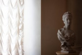Statue next to a window at Saint Petersburg's State Hermitage Museum